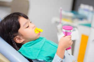 child with a mouthguard in, fluoride treatments tx