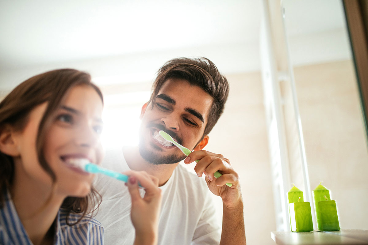 couple brushing teeth, how to prevent tooth decay naturally