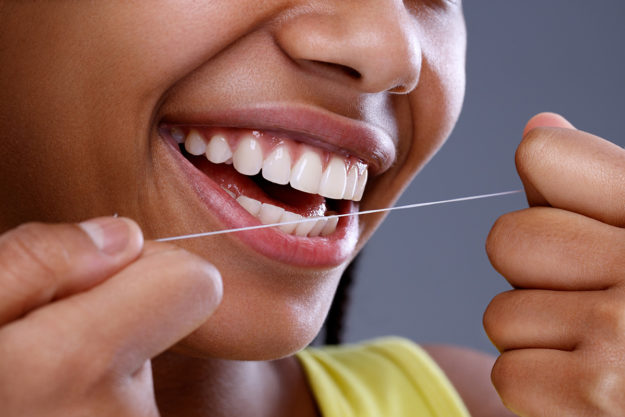 benefits of flossing daily (5) individual showing the benefits of flossing daily