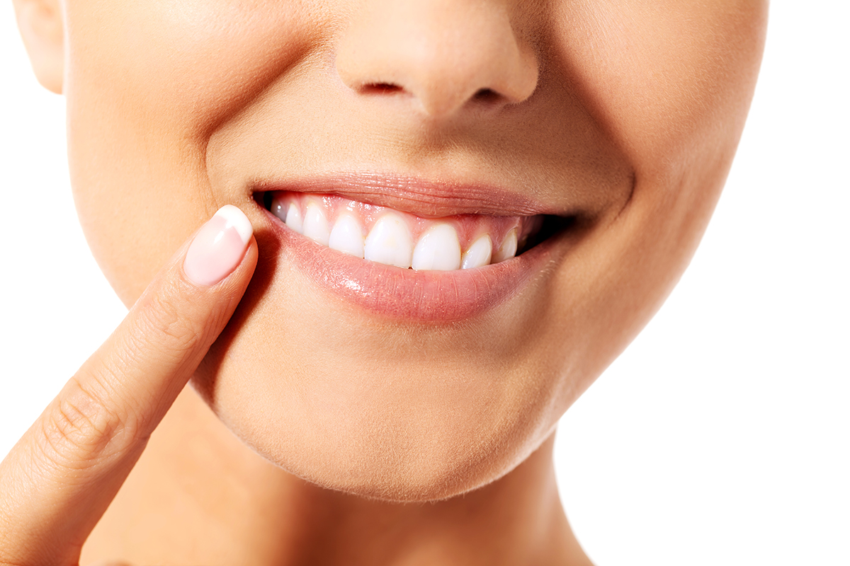 causes of receding gums woman showing causes of receding gums
