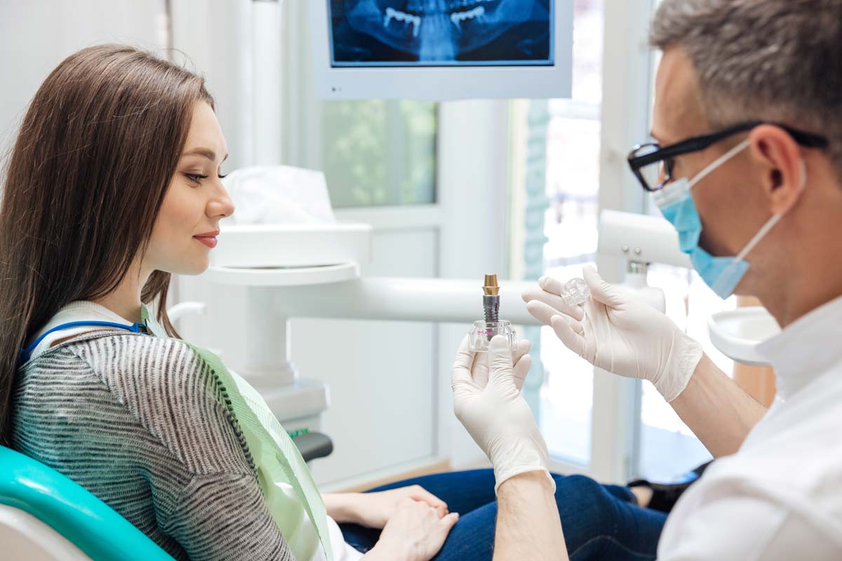 patient looking at types of dental implants