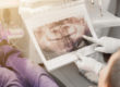 dentist looking at dental x rays