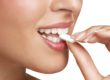 person eating piece of chewing gum and health