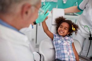 young girl having pediatric dentistry services completed